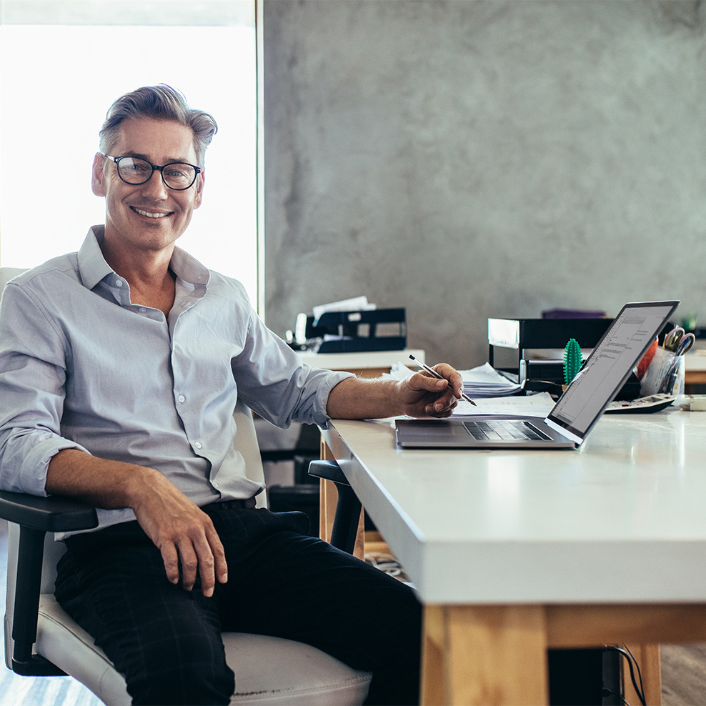 Business owner in office on computer happy with ABOBA Digital IT Solutions for Businesses in Houston