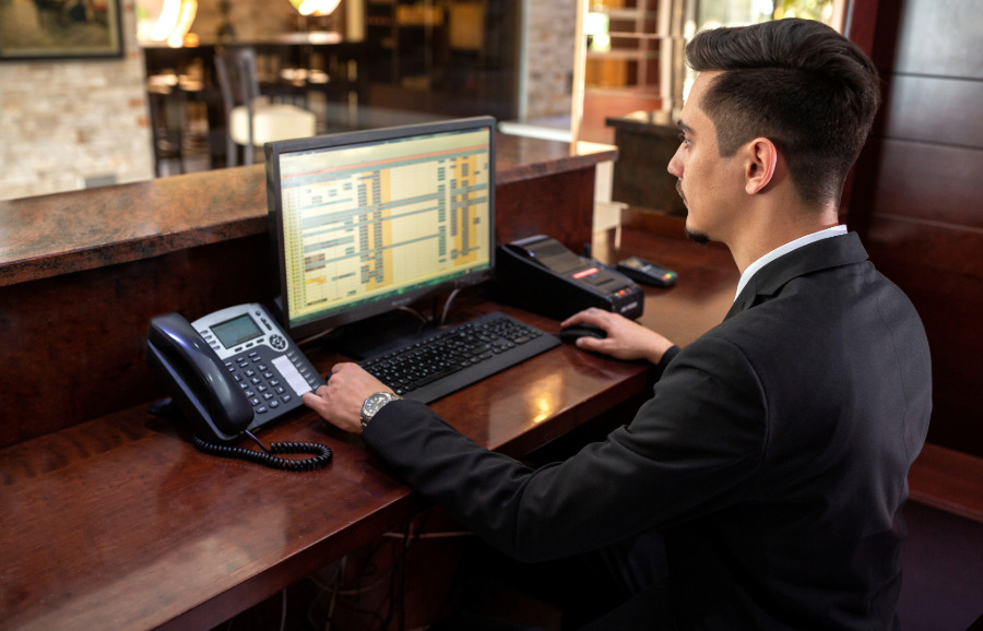 Hotel IT Solutions Hotel IT Solutions. Hotel staff at front desk.
